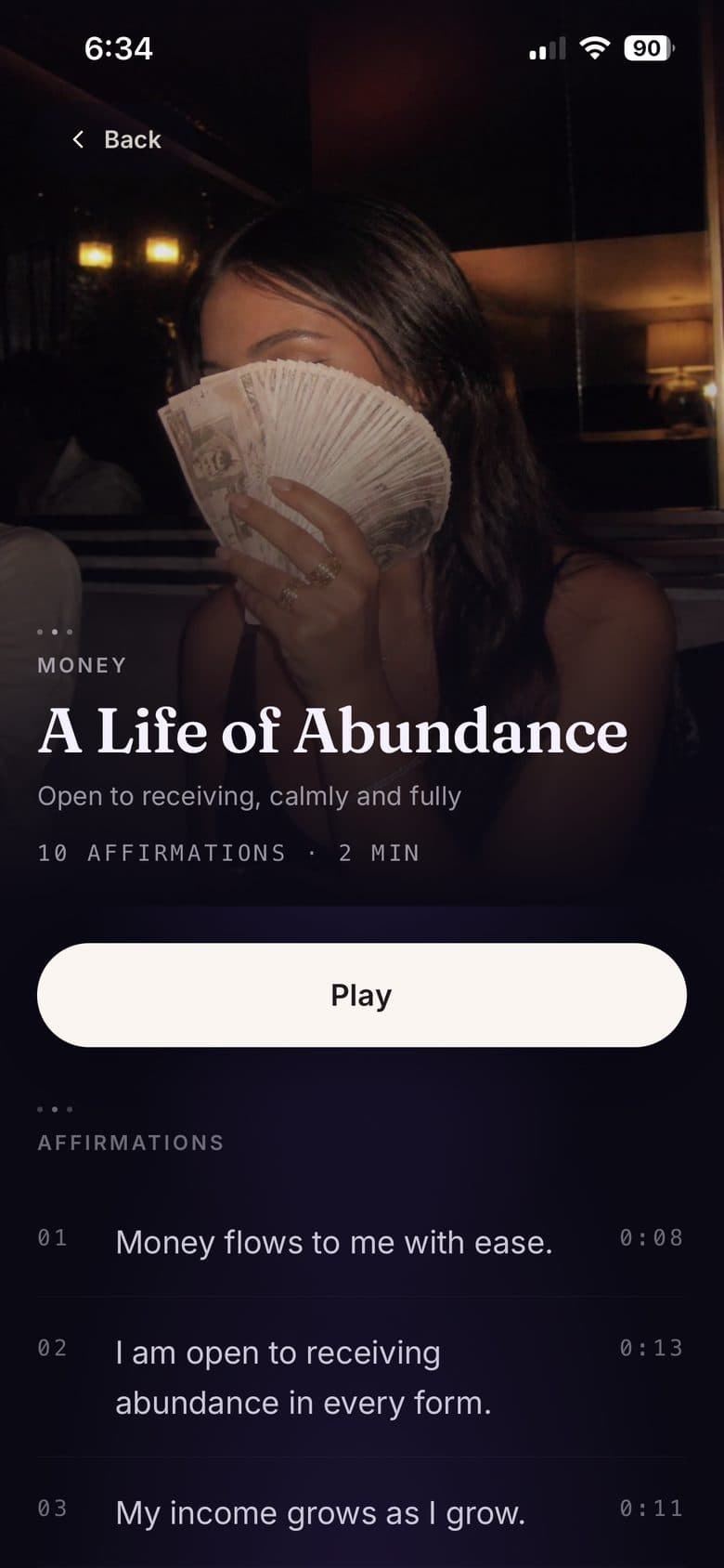 A playlist at night: a photograph filling the header, a Play button, and the affirmations it holds listed underneath.